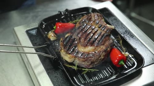 the chef prepares delicious meat in the restaurant
