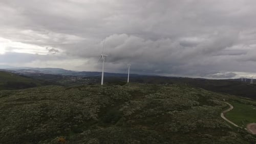 Aerial View of Wind Turbines or Windmills Farm Field in Industry Factory with Fog