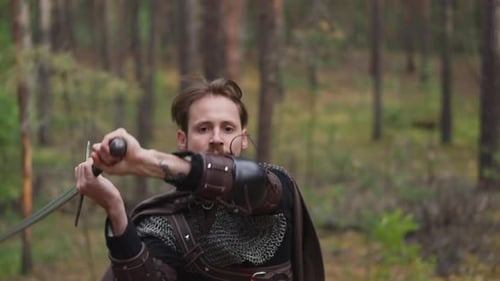 Man in Armor Wields Sword in Forest Fencing