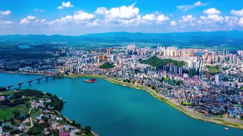 Modern city financial district skyline and natural scenery with green blue river sky cloud