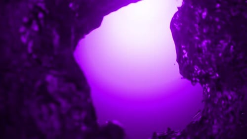 Purple water vortex spinning in slow motion. 3d loop animation 4k