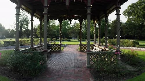Aerial view flying through the rose garden arbor in Roger Williams Park.