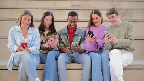 Young Adults Use Cell Phones on Urban Steps