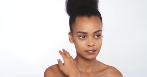 Elegant Woman Touches Her Face in a White Studio