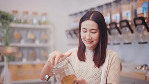 Portrait of a happy young woman in a zero waste refill store