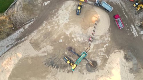 Aerial view of sand quarry, industrial extraction of sand for construction industry. Excavators and
