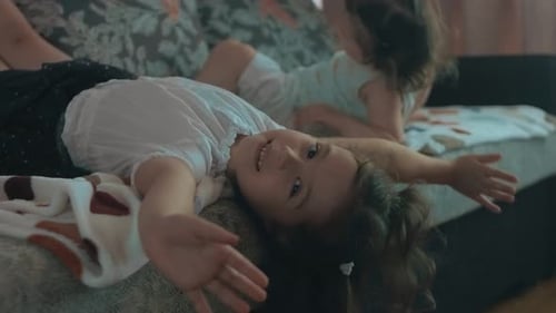 Two Young Girls Relaxing on the Couch
