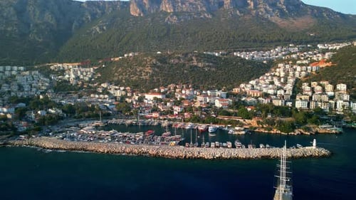 Aerial view of harbor with boats and mountains, Turkey.
