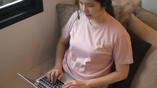 Asian woman working at home, sipping tea