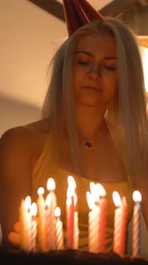 Woman With Birthday Cake and Lit Candles