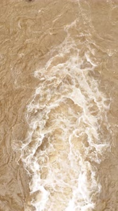 Drone view from top of brown river water