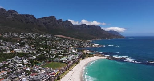 Aerial Pullback Reveals Beautiful Camps Bay Beach in Cape Town, South Africa. Summer Day