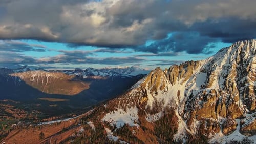 Rocky Snow Mountains at Sunset Aerial