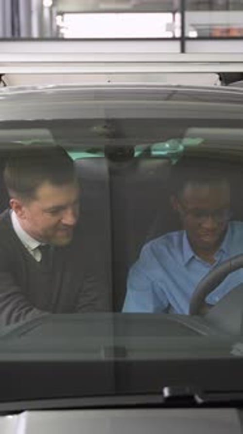 Salesman Presents Car to Buyer Before Purchase in Dealership