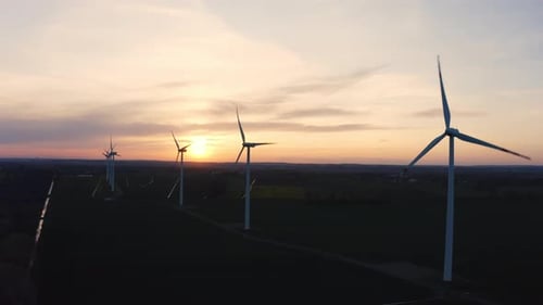 Cinematic Aerial View Drone Shot of a Wind Turbine Farm During Sunset