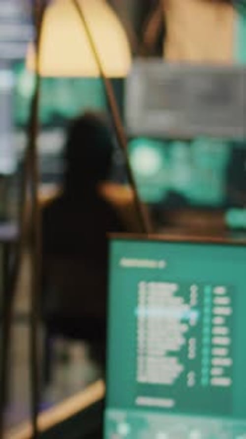 Person Programming at Computer Bank in Dark Room