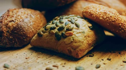Variety of Delicious Baked Breads on Wooden Table