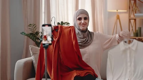 Young Female Blogger Shows Clothes Talking Enthusiastically