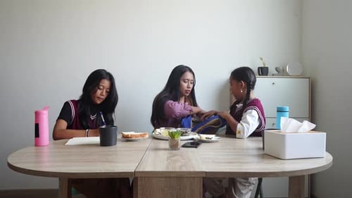 Young Asian Mother Helps Her Little Child Prepare To Go To School