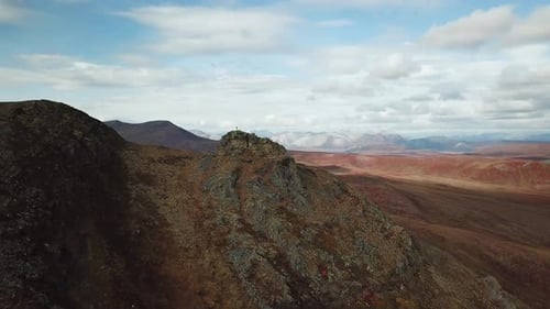 Hiker standing alone on top of the mountain