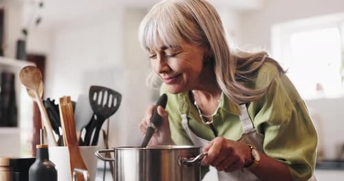 Senior Woman Cooking in Kitchen at Home
