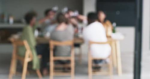 Blurred View of Friends Gathering Indoors at Table