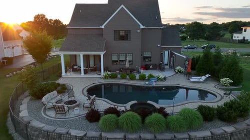 Private pool in back yard. Luxurious home in American country club community. Rising aerial reveal o