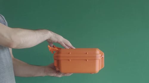 Man Opens Protective Orange Case