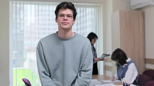 Portrait of College Student Guy Looking at Camera Inside Classroom