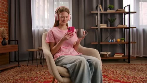 Young Woman Relaxing at Home With Smartphone