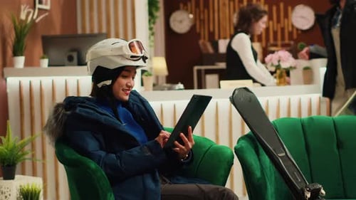 Woman Navigating on Tablet in Lobby