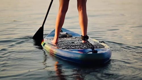 Paddleboard Adventure on a Calm Lake at Sunset