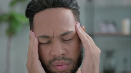 Close up of Hispanic Man with Headache