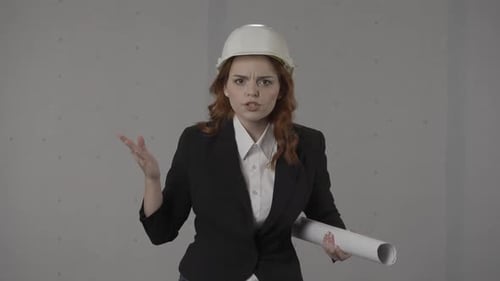 Upset Woman Arguing with Construction Plans