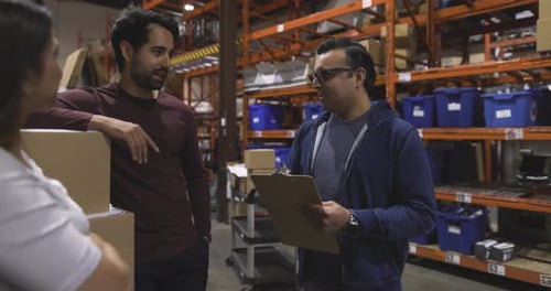 Manager And Workers Meeting Talking In Distribution Warehouse Slow Motion