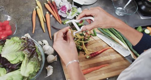 Woman Peeling a Carrot for a Fresh Salad