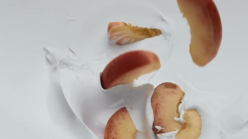 Slices Sweet Peach Falling Into Fresh Creamy Yogurt in Super