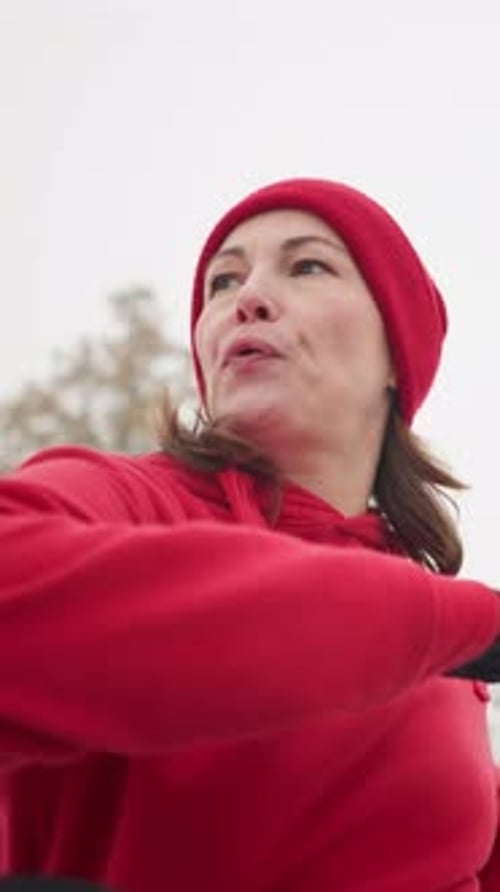 Woman Stretching Arms Outdoors in Winter Weather