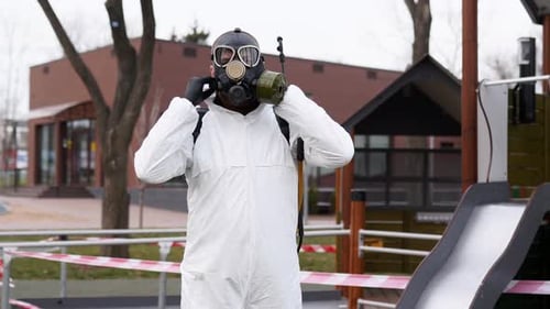 Man in Hazmat Suit Puts on Full Face Mask