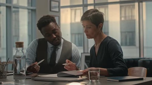 Colleagues Reviewing Documents in Modern Office Setting