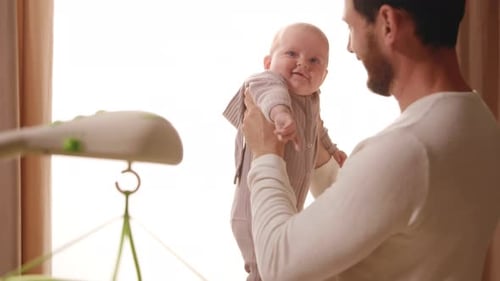 Portrait Young Father Gently Hugs a Newborn Baby Crying in His Arms Playing Together Standing at