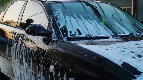 Washing Luxury Black Car on Touchless Car Wash Cleaning the Details of Car Washing Sedan Car with