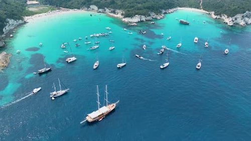 Aerial View of a Popular Paradise Beach and Bay Filled with Boats and Yachts in Blue Water