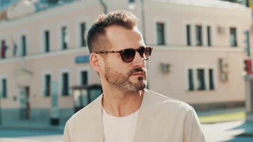 Stylish Man Posing on City Street on Sunny Day