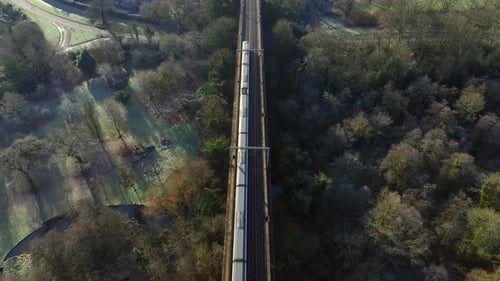 Commuter Train Passing Over a Beautiful Viaduct in the Evening