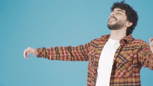 Happy handsome handsome young man dancing, having fun in casual clothes.