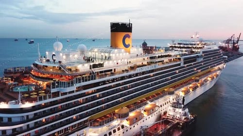 Large Cruise Ship Docked at Port During Sunset