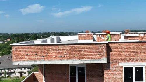Engineers and Architects Walk on the Roof of the Building and Inspect the Construction Site