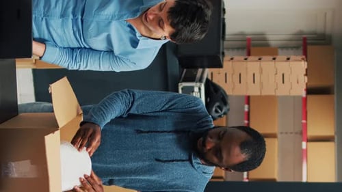Vertical Video Employees Putting Products in Boxes and Dong Highfive