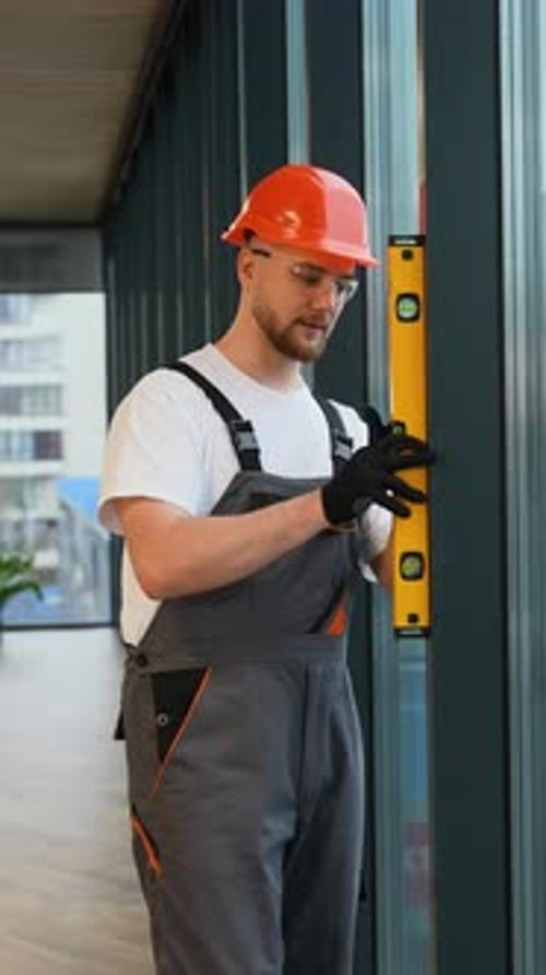 Construction Worker Using Spirit Level in Modern Interior